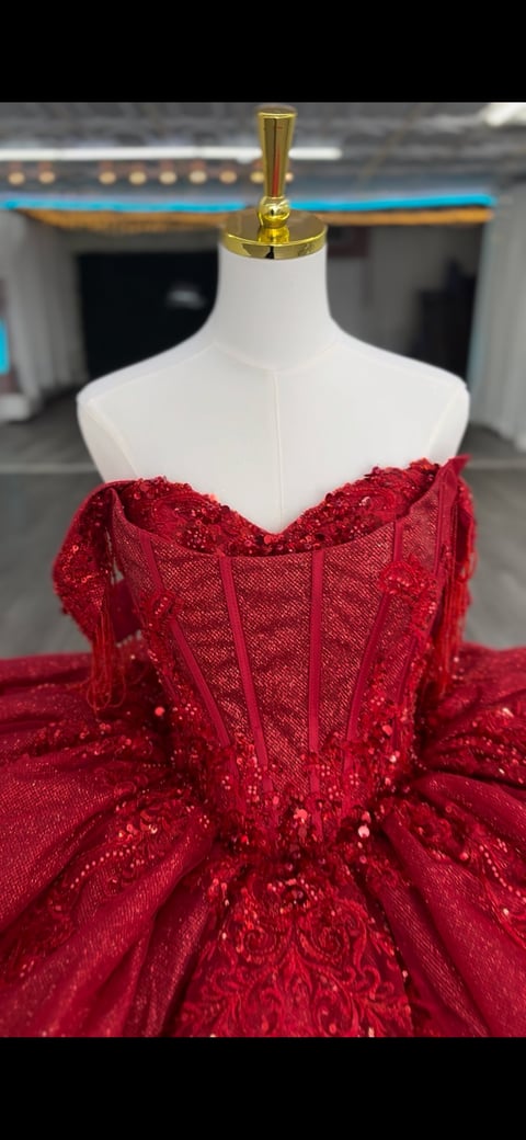 Red beaded ball gown on dress form